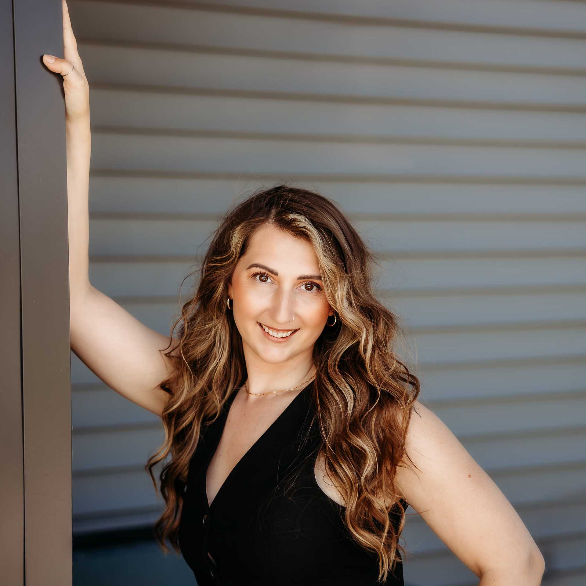 Portrait of Hilary R., a professional stylist at Revive Salon & Spa, showcasing their expertise and style.