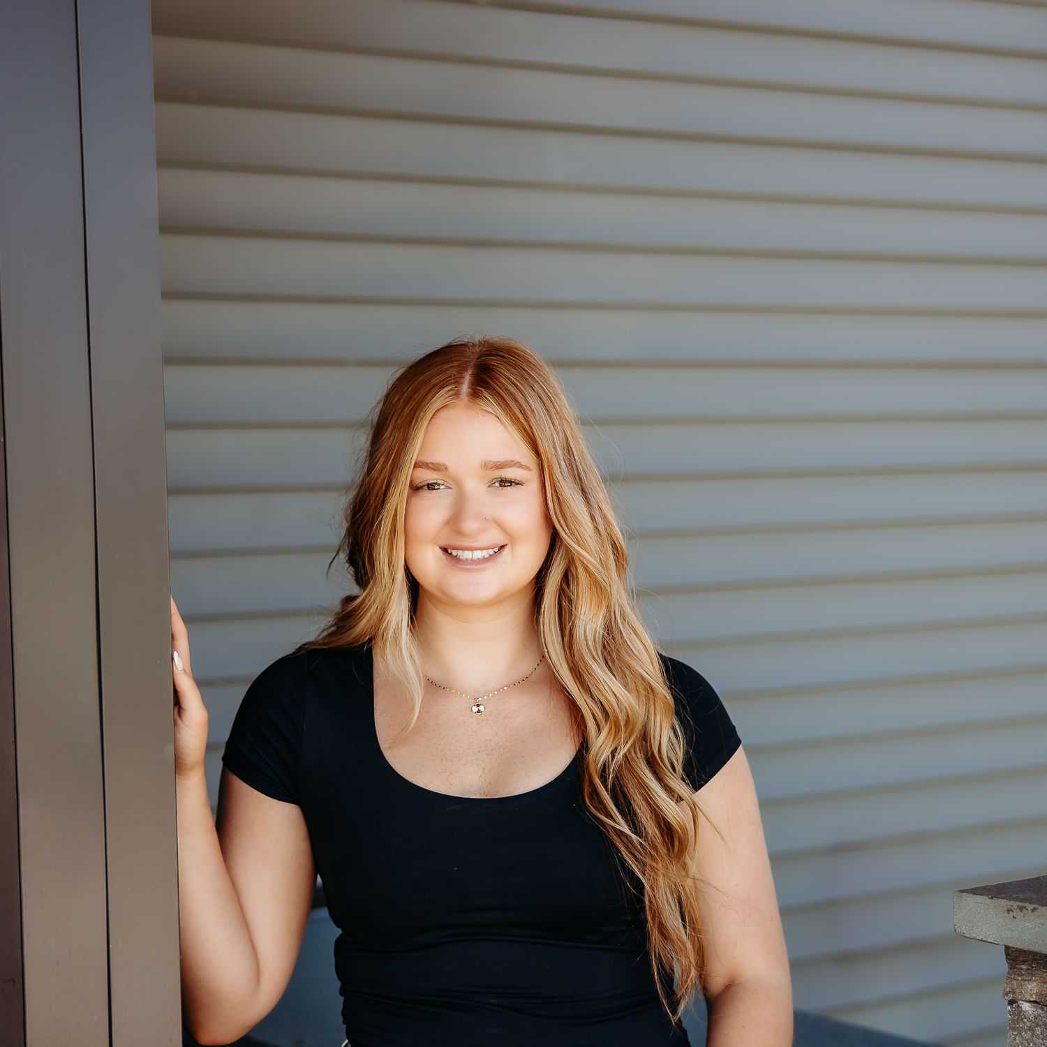 Portrait of Faith R., a professional stylist at Revive Salon & Spa, showcasing their expertise and style.