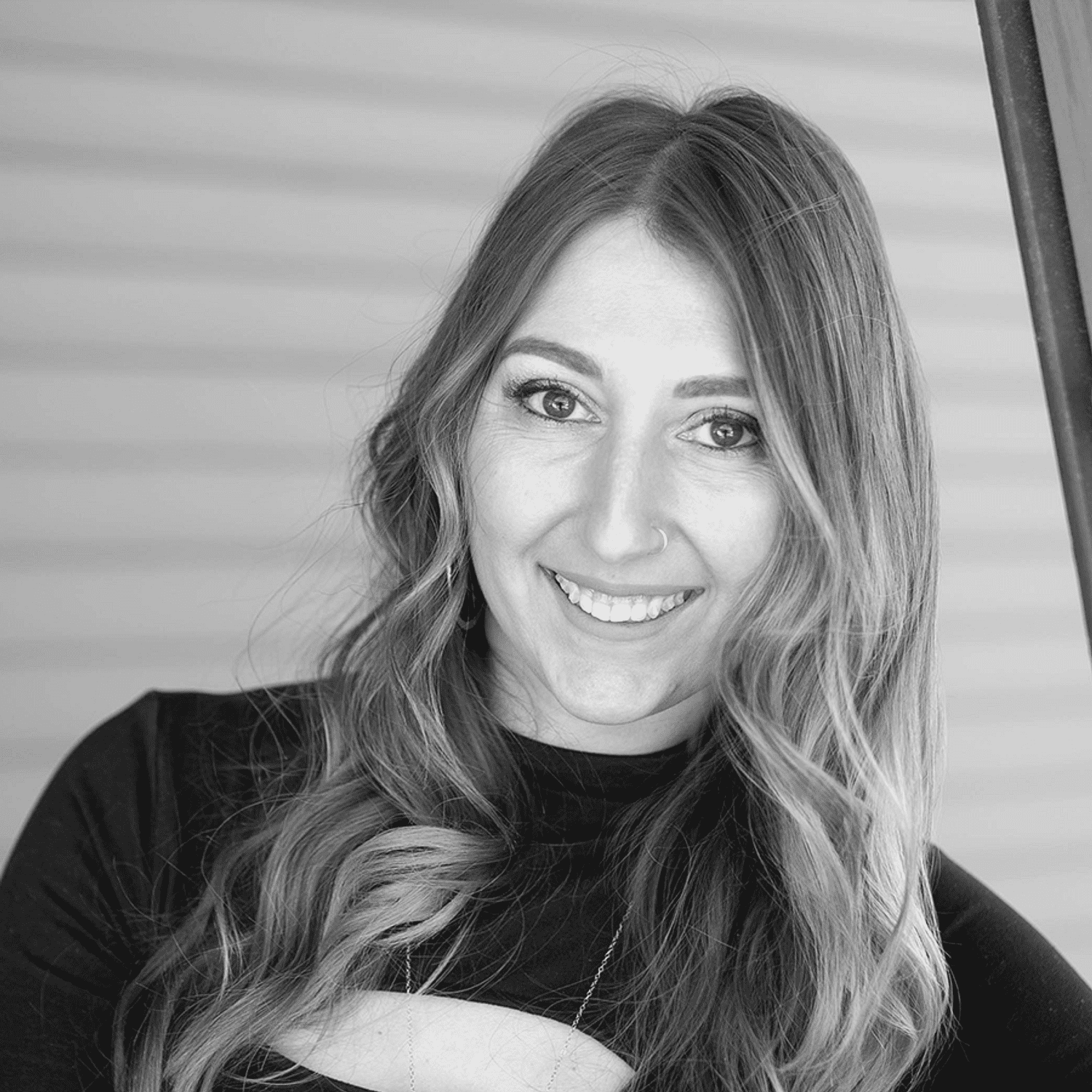 Portrait of Hilary R., a professional stylist at Revive Salon & Spa, showcasing their expertise and style.