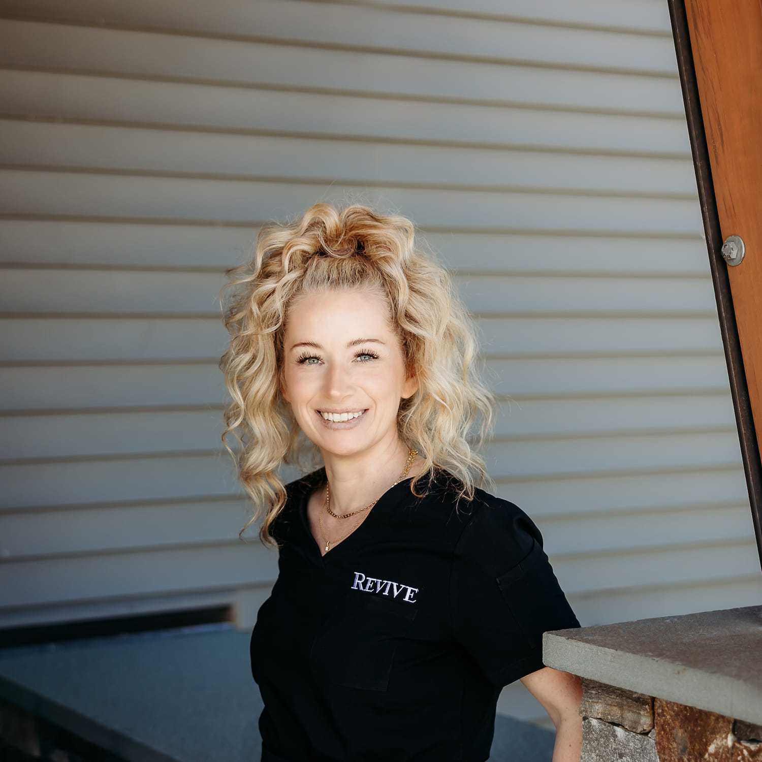 Portrait of Heather F., a professional stylist at Revive Salon & Spa, showcasing their expertise and style.